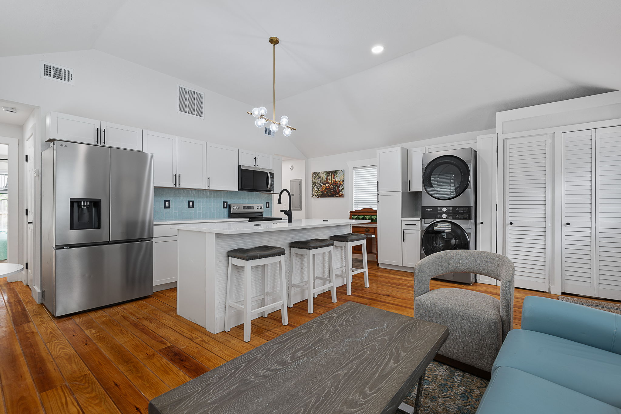 Kitchen prep zone with stacked in-unit laundry
